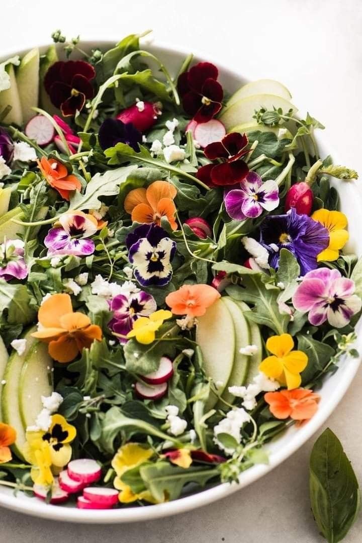 Beautiful salad topped edible purple and yellow violets